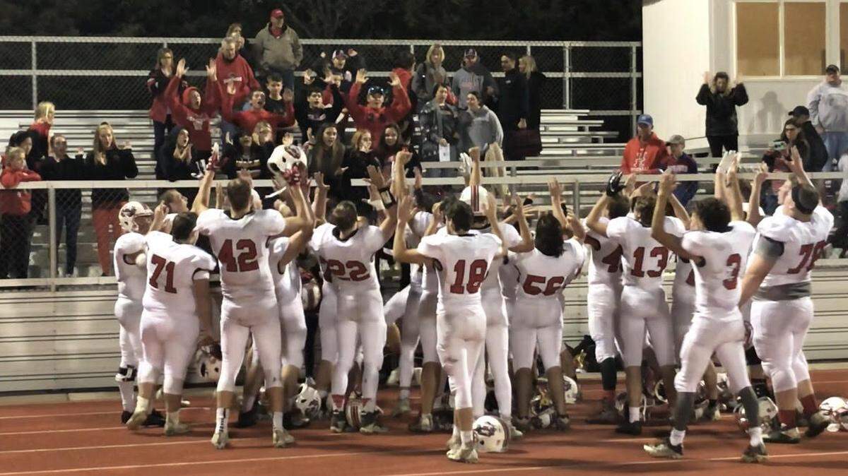 The Hesston players celebrated with some of the team’s fans after its first-round playoff victory at Collegiate on Friday night.