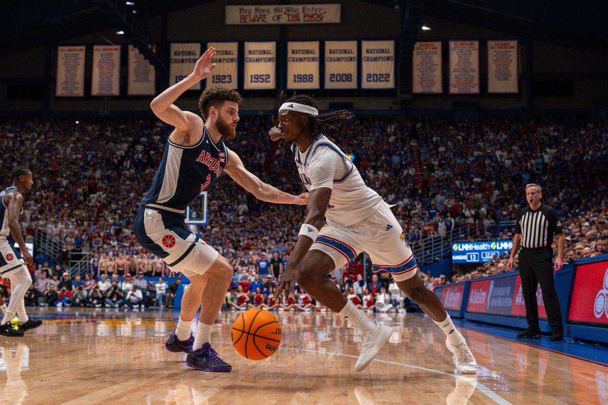 Kansas Jayhawks guard Jamari McDowell (11) drives towards the paint against Arizona Wildcats guard Anthony Dell’orso (3) in the first half on Monday, February 9, 2026, at Allen Fieldhouse.