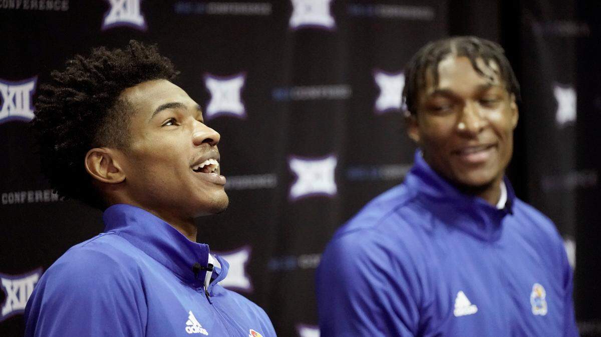 Kansas players Ochai Agbaji, left, and David McCormack talk to the media during Big 12 NCAA college basketball media day Wednesday, Oct. 20, 2021, in Kansas City, Mo. (AP Photo/Charlie Riedel)