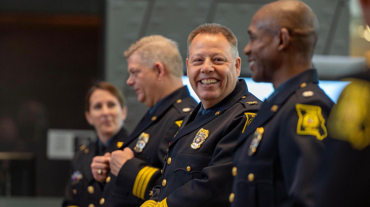 Kansas City Chief of Police Rick Smith speaks to incoming interim police chief Joseph Mabin before the Board of Police Commissioners meeting at Kansas City Police Headquarters on Tuesday, April 19, 2022.