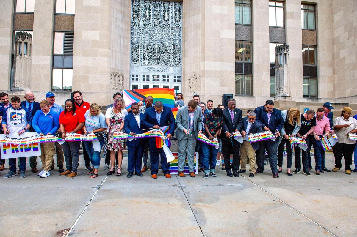 Legislators and LGBTQ activists cut a ribbon after a celebratory kickoff to Pride Month at the Jackson County Courthouse in Kansas City on Wednesday, June 1, 2022.