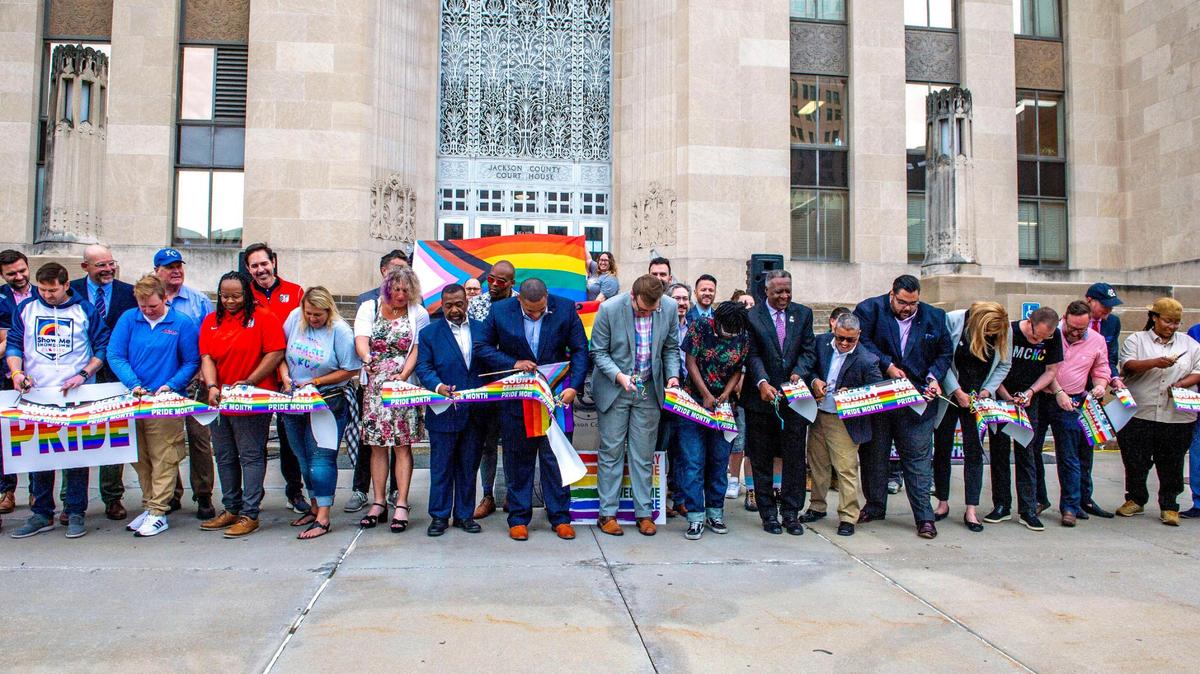 Legislators and LGBTQ activists cut a ribbon during a celebratory kickoff to Pride month at the Jackson County Courthouse in Kansas City on Wednesday, June 1, 2022.