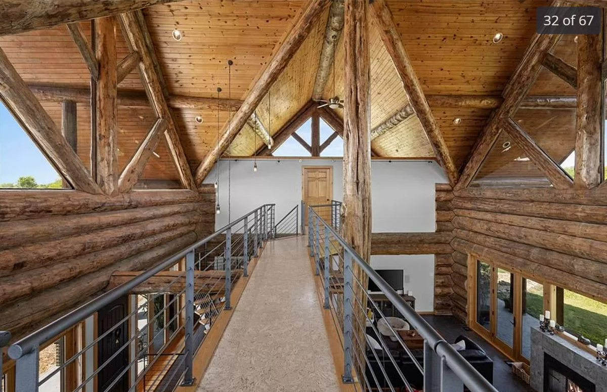 An elevated catwalk is seen above the main floor of the log cabin-style home at 13708 South Missouri 7 Highway.