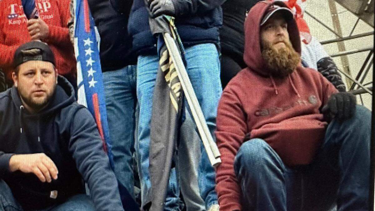 The government said Eric Harrower, right, and Joshua Dressel, sitting left, manned an overturned bike rack and appeared to watch as the mob attacked police during the Capitol riot.