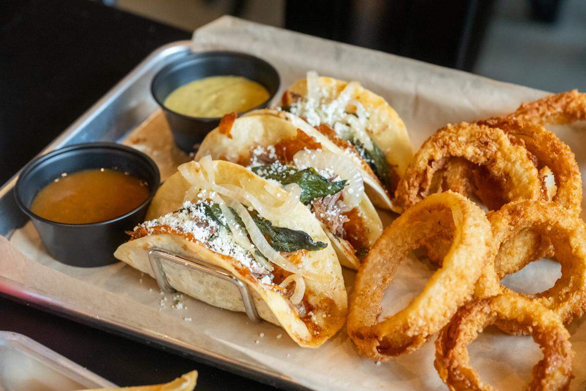 Brisket tacos and onion rings are on the menu at Joe's Next Door.