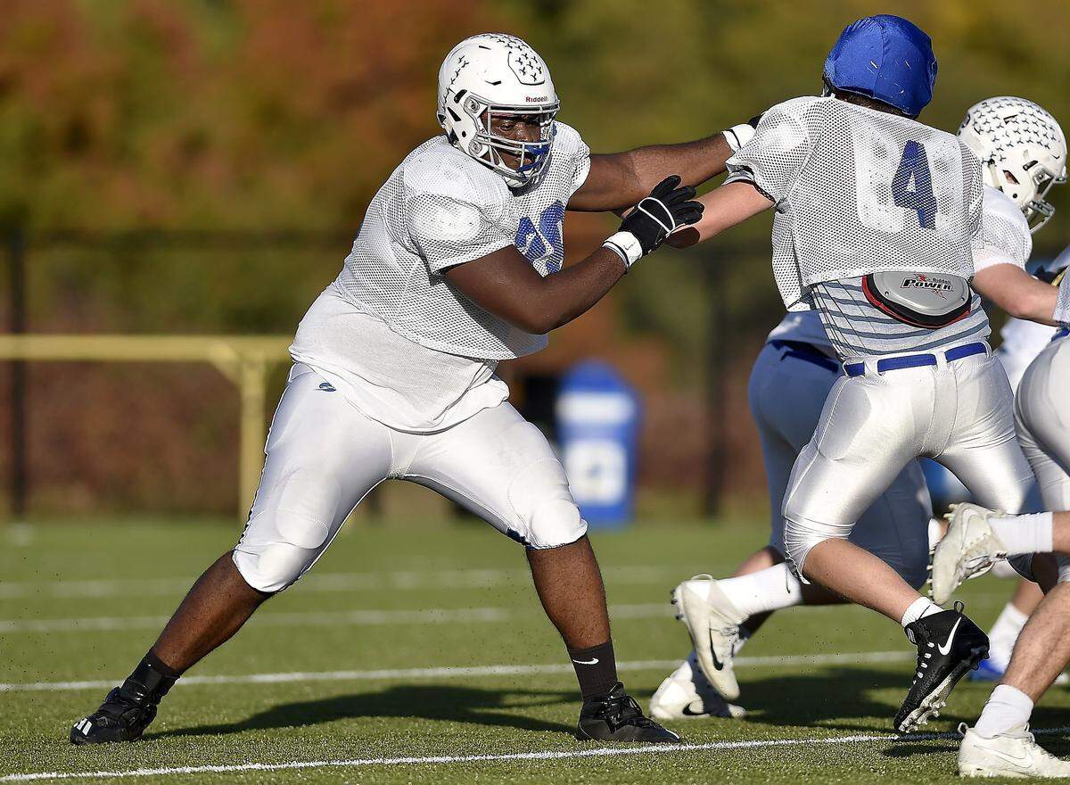 Danielson Ike (left) towers over most of his teammates and opponents and has dreams of one day starring in the NFL.