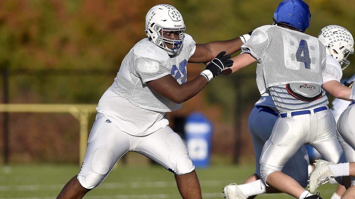 Danielson Ike (left) towers over most of his teammates and opponents and has dreams of one day starring in the NFL.