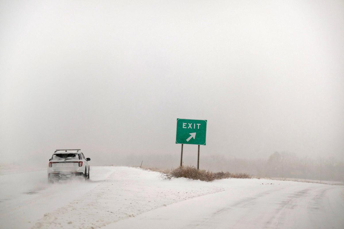 Snow-packed roads and blizzard conditions were slowing a driver heading westbound Kansas 10 Highway on Sunday, Jan. 5, 2025, in western Lenexa.