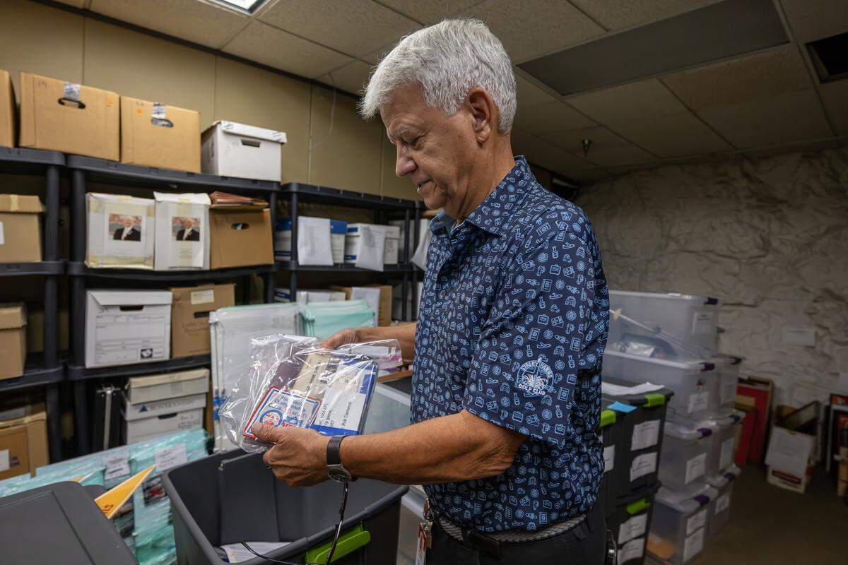 Kansas City Chiefs historian Mike Davidson showcases patches from a championship game in the Artifact Room inside the team’s underground storage facility.