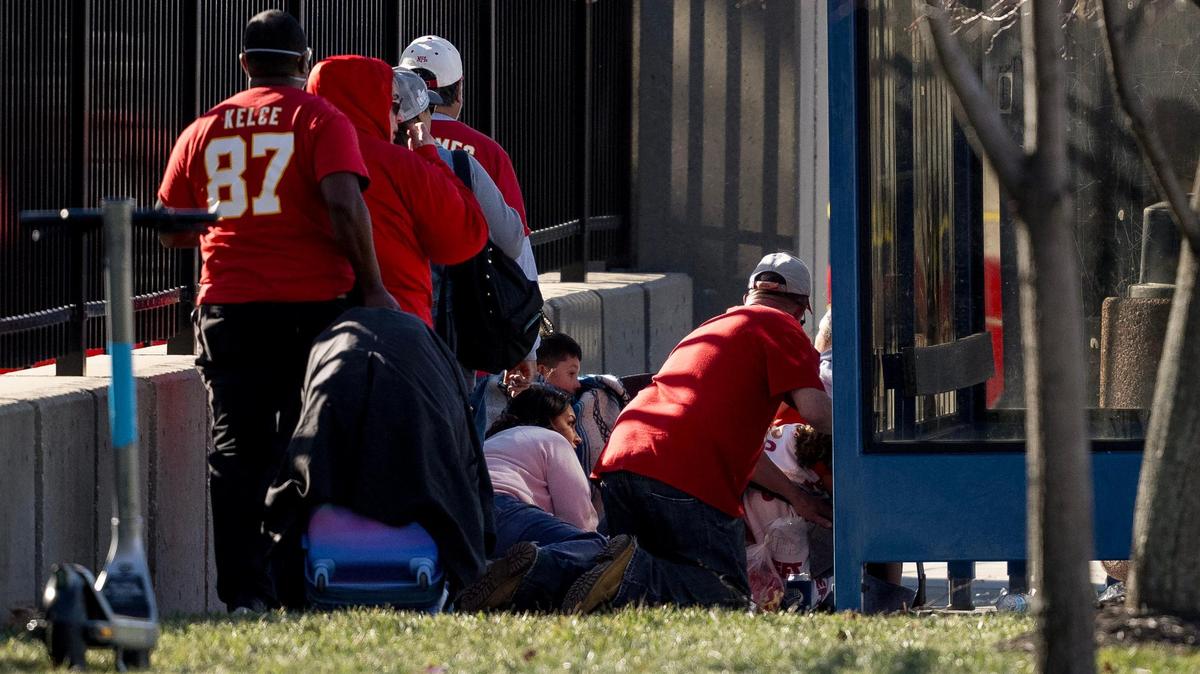 People take cover after a shooting broke out following the Kansas City Chiefs Super Bowl LVIII victory parade on Wednesday, Feb. 14, 2024, in Kansas City.