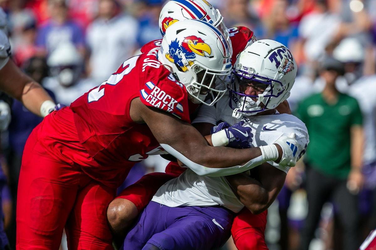 Kansas Jayhawks defensive tackle Tommy Dunn Jr. flattens TCU running back Jeremy Payne during Saturday’s game at GEHA Field at Arrowhead Stadium.