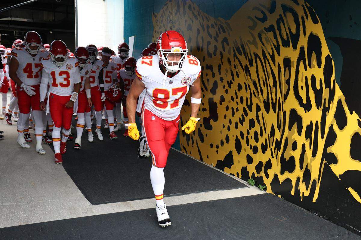Kansas City Chiefs tight end Travis Kelce (87) leads the team on to the field for warm ups before a preseason game against the Jacksonville Jaguars at EverBank Stadium.