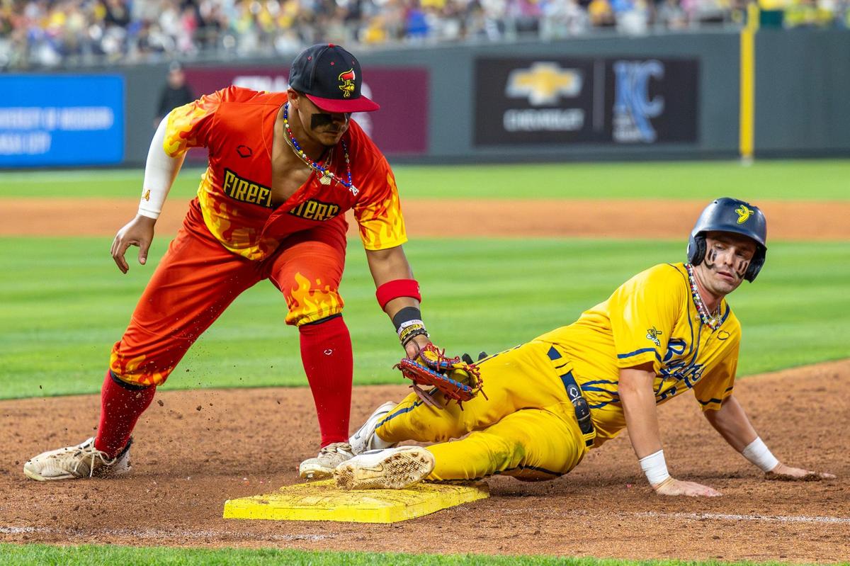 Savannah Bananas shortstop Ryan Cox (6) slides into first base in the eighth inning during a Banana Ball game against the Firefighters at Kauffman Stadium on Friday, May 23, 2025, in Kansas City.