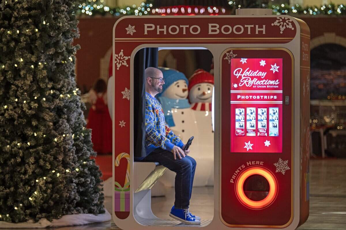 Zak Holder of Blue Springs sat in the photo booth for a photo as final touches were being put on “Holiday Reflections” at Union Station on Thursday, November 20, 2025, in Kansas City. The annual holiday display is billed as Kansas City's largest holiday walk-through experience, filling 27,000 square feet of the historic Grand Plaza.