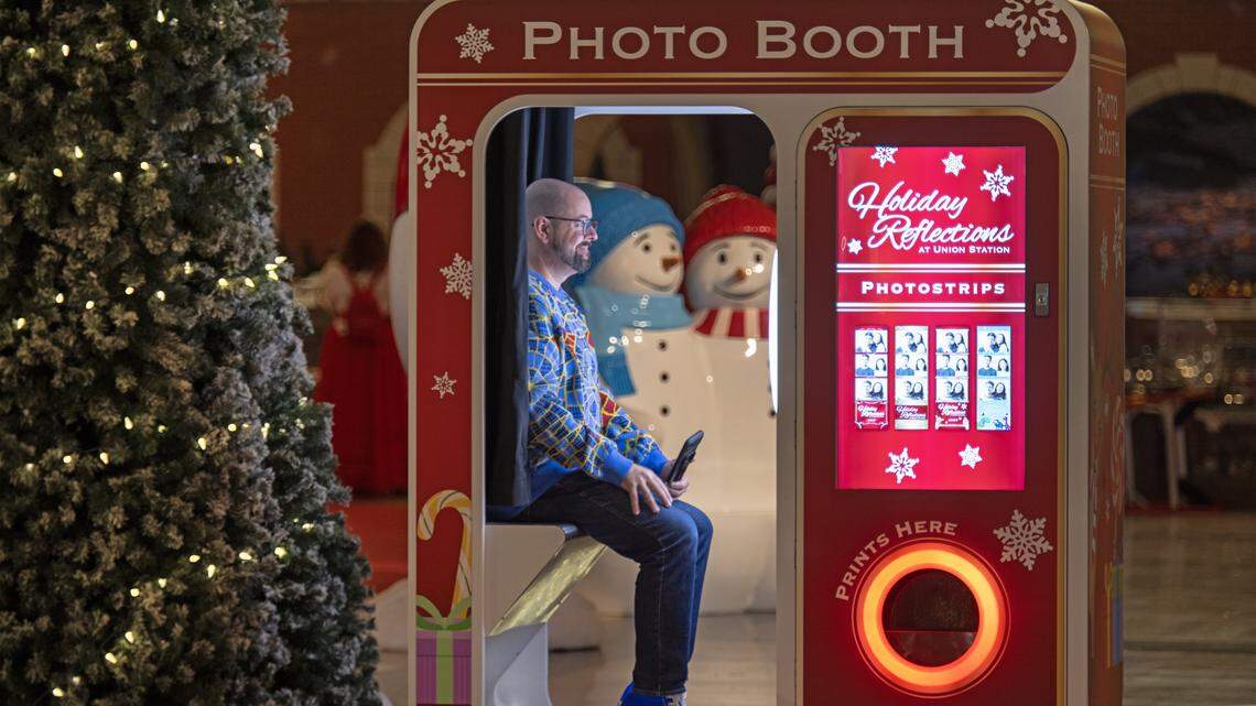Zak Holder of Blue Springs sat in the photo booth for a photo as final touches were being put on “Holiday Reflections” at Union Station on Thursday, November 20, 2025, in Kansas City. The annual holiday display is billed as Kansas City's largest holiday walk-through experience, filling 27,000 square feet of the historic Grand Plaza.