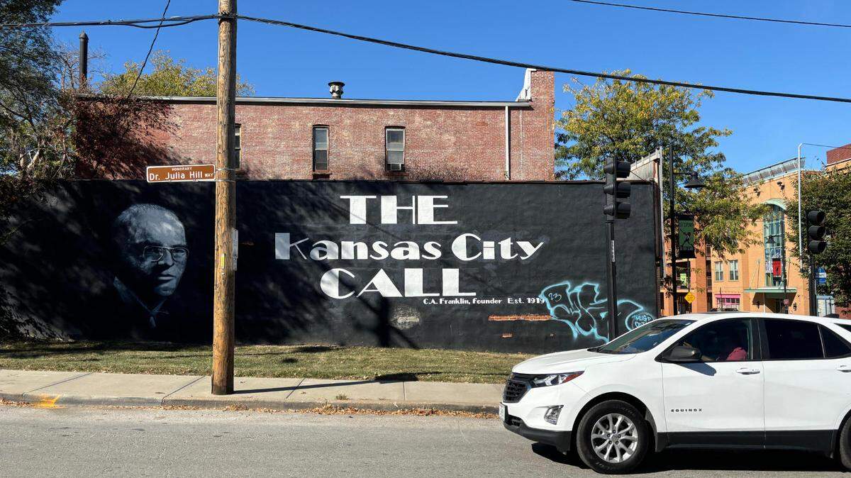 A car drives down Woodland Ave in the 18th and Vine District, past the historic Call newspaper building. The structure, which held the African American community newspaper, was sold in October 2024.