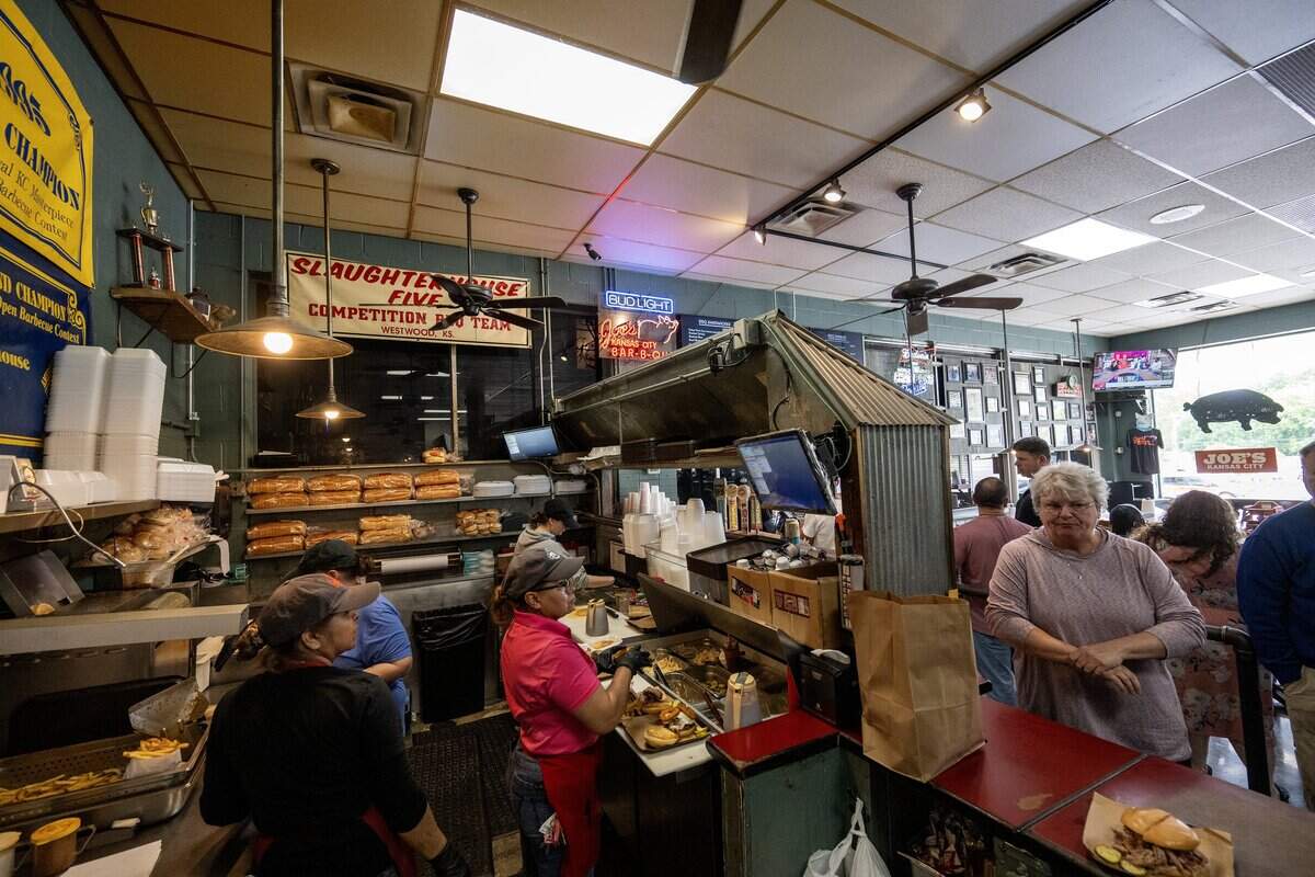 Guests wait in line as staff prepare orders inside Joe's KC BBQ on Thursday, April 30, 2026, in Kansas City, Kansas.