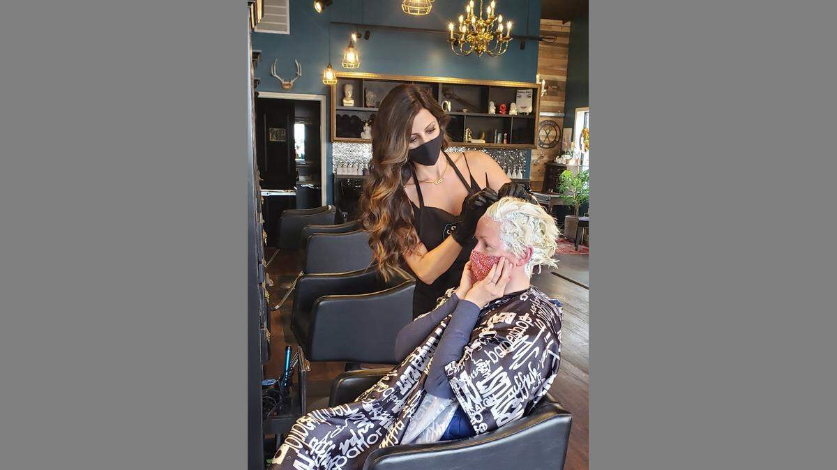Coco McKie, owner of Coco’s Style Lounge, was able to open doors to clients, like Cameron Taylor, on Monday, May 11.