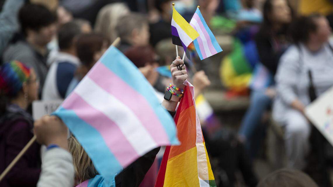 People gather for a rally organized by LGBTQ youth and adults in opposition to Senate Bill 150 and also to celebrate Trans Day of Visibility in Lexington, Ky., Friday, March 31, 2022. transgender flag ally kentucky