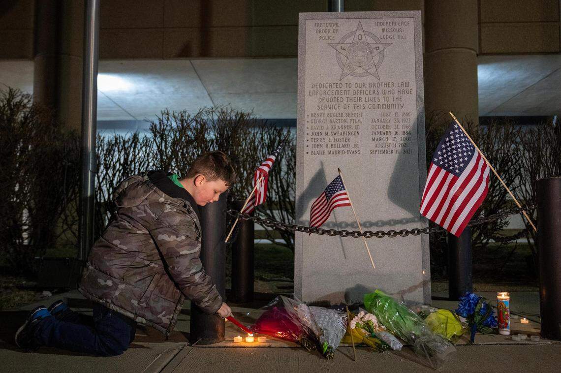 Daniel Turner, 7, son of a Buckner police officer and the nephew of an Independence police officer, lit candles as he paid his respects to fallen Independence police officer Cody Allen, at the police memorial outside of the Independence Police Department, 223 N. Memorial Dr.. on Thursday, Feb. 29, 2024, in Independence. Daniel visited the memorial with his mother, Heather Parsons, of Independence, who said she learned of the shooting when Daniel’s school, Elm Grove Elementary went on lock down in the Fort Osage School District.