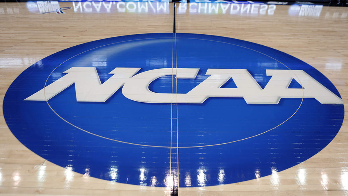 FILE - In this March 18, 2015, file photo, the NCAA logo is displayed at center court as work continues at The Consol Energy Center in Pittsburgh, for the NCAA college basketball tournament. NCAA President Mark Emmert says NCAA Division I basketball tournament games will be played without fans in the arenas because of concerns about the spread of coronavirus. (AP Photo/Keith Srakocic, File)