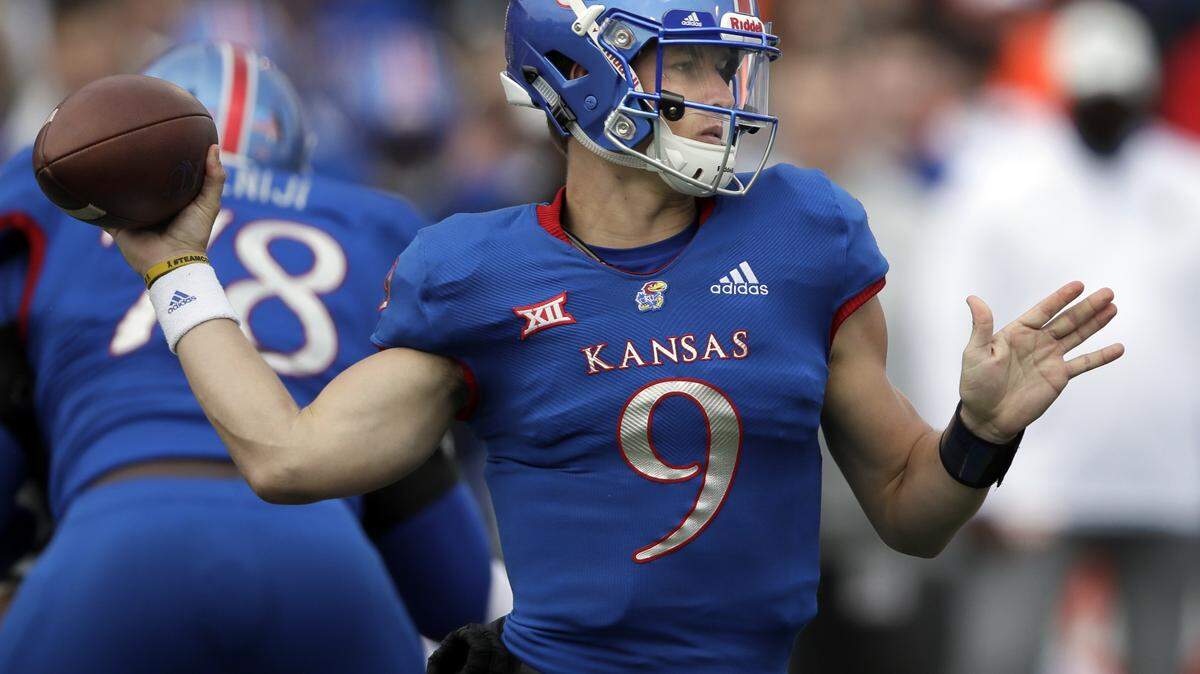 Kansas quarterback Carter Stanley (9) throws a pass during the first half of an NCAA college football game against Oklahoma State in Lawrence, Kan., Saturday, Sept. 29, 2018. (AP Photo/Orlin Wagner)