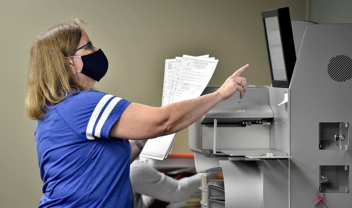 Election worker Gloria Peterson prepares mail-in ballots for scanning Thursday, Oct. 29, 2020, at the Johnson County Election Office in Olathe. Mail-in ballots are scanned and their images stored ahead of Election Day.