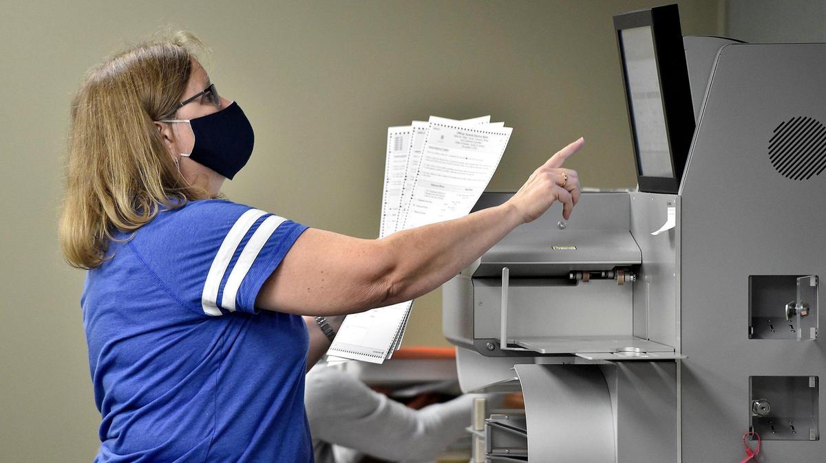 Election worker Gloria Peterson prepares mail-in ballots for scanning Thursday, Oct. 29, 2020, at the Johnson County Election Office in Olathe. Mail-in ballots are scanned and their images stored ahead of Election Day.
