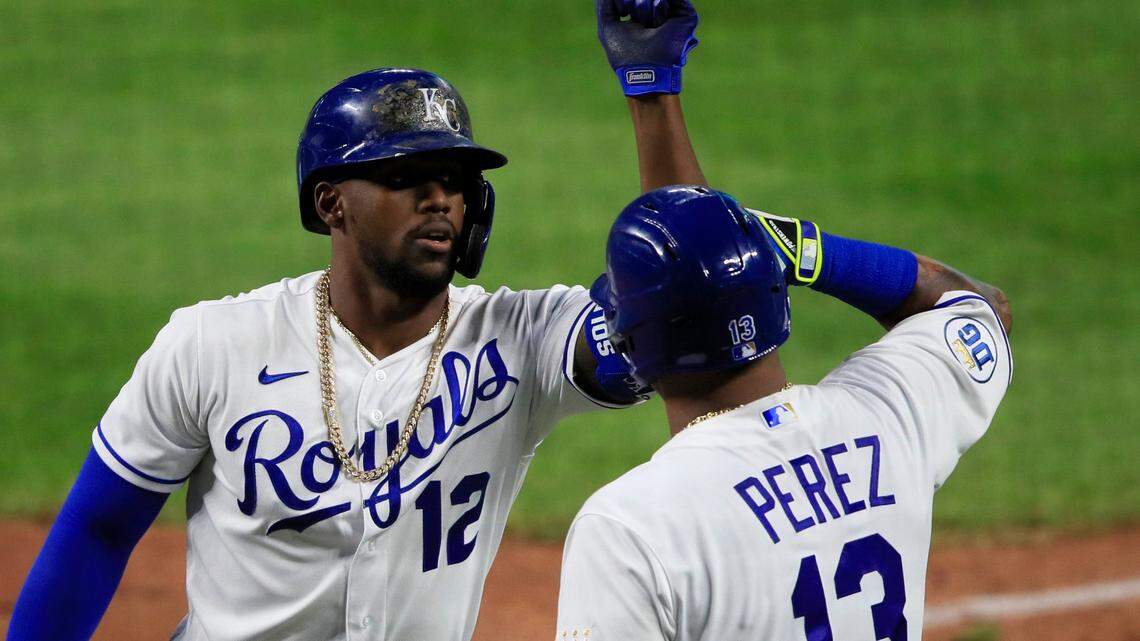 Kansas City Royals Jorge Soler (12) is congratulated by teammate Salvador Perez (13) after his solo home run during the seventh inning of a baseball game against the Chicago Cubs at Kauffman Stadium in Kansas City, Mo., Thursday, Aug. 6, 2020. (AP Photo/Orlin Wagner)
