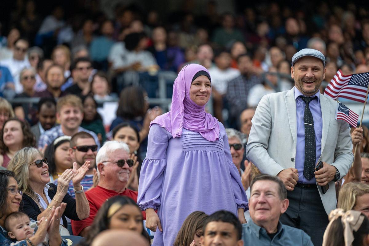 Fatima and Senaid Hodzic of Bosnia stood as their country was recognized before they took the Oath of Allegiance to become American citizens Thursday. The couple now live in Kansas City.