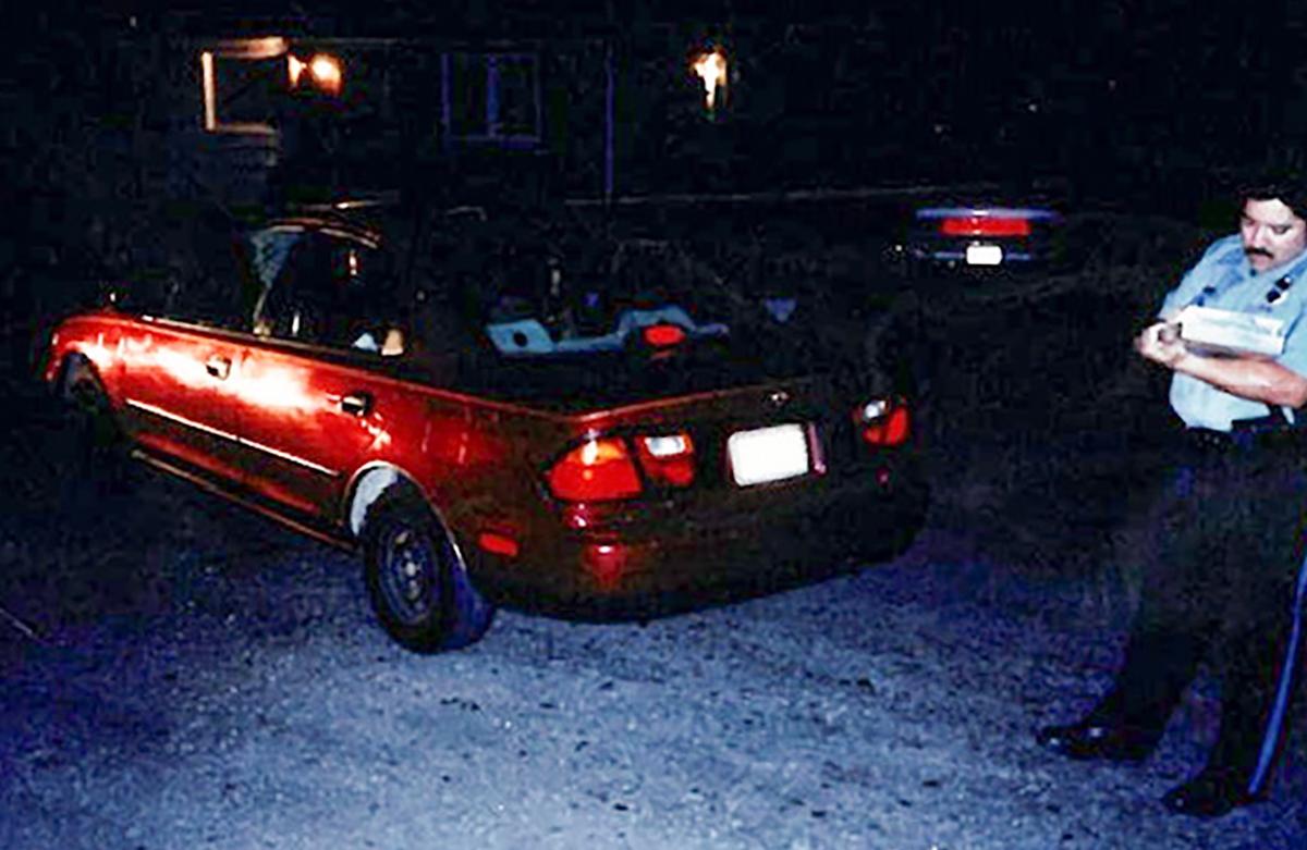 A police officer takes notes at the homicide of Robert Diaz Jr., on April 17, 2000, at South Minnie Street and West 40th Avenue in Kansas City, Kansas.
