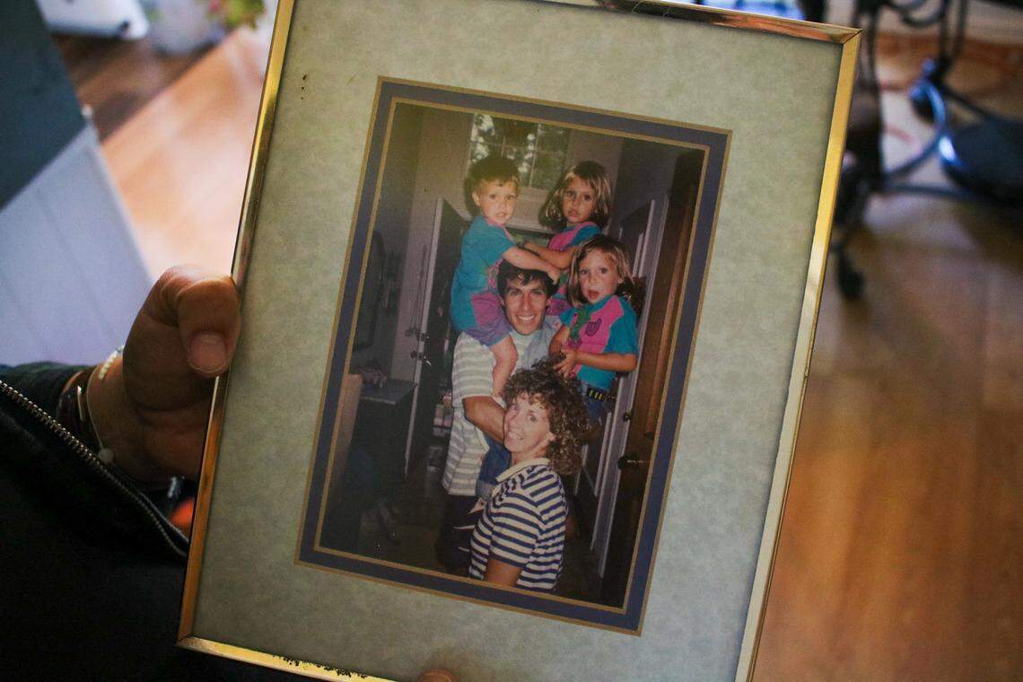 Lisa Rodriguez holds her favorite family photo, showing her father Keno Rodriguez, and mother Anne Rodriguez, holding Lisa and her siblings, Matais and Jessica Rodriguez.