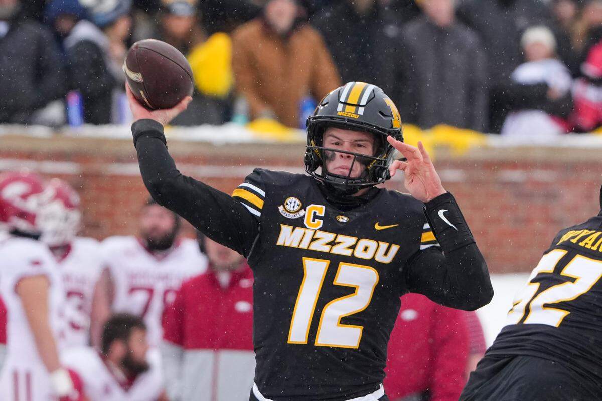 Missouri Tigers quarterback Brady Cook throws a pass against the Arkansas Razorbacks during the regular-season college football finale for both teams at Faurot Field at Memorial Stadium in Columbia on Saturday, Nov 30, 2024.