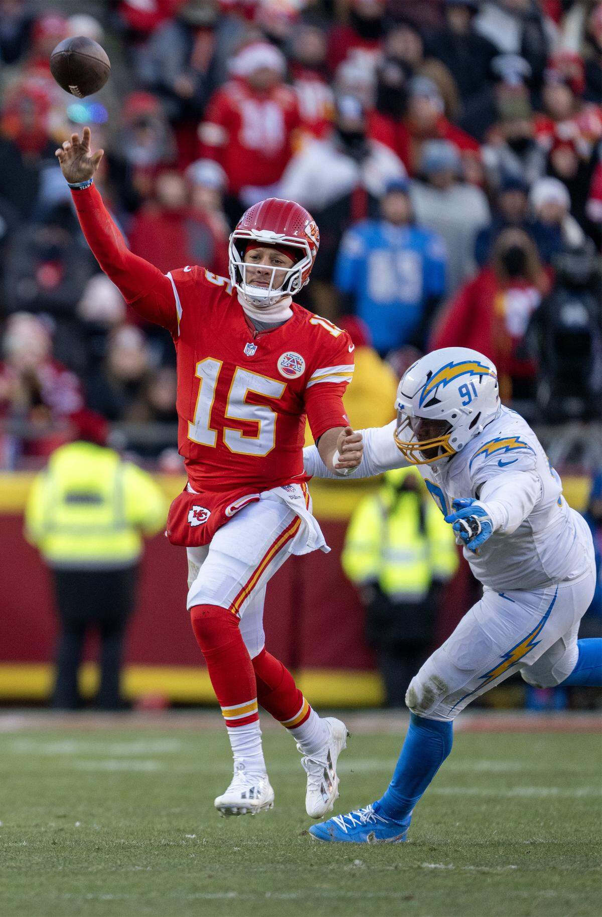 Kansas City Chiefs quarterback Patrick Mahomes (15) throws a pass under pressure form Los Angeles Chargers defensive tackle Da’Shawn Hand (91) in the fourth quarter on Sunday, Dec. 14, 2025 at GEHA Field at Arrowhead Stadium in Kansas City. Mahomes was hurt at the end of the play.