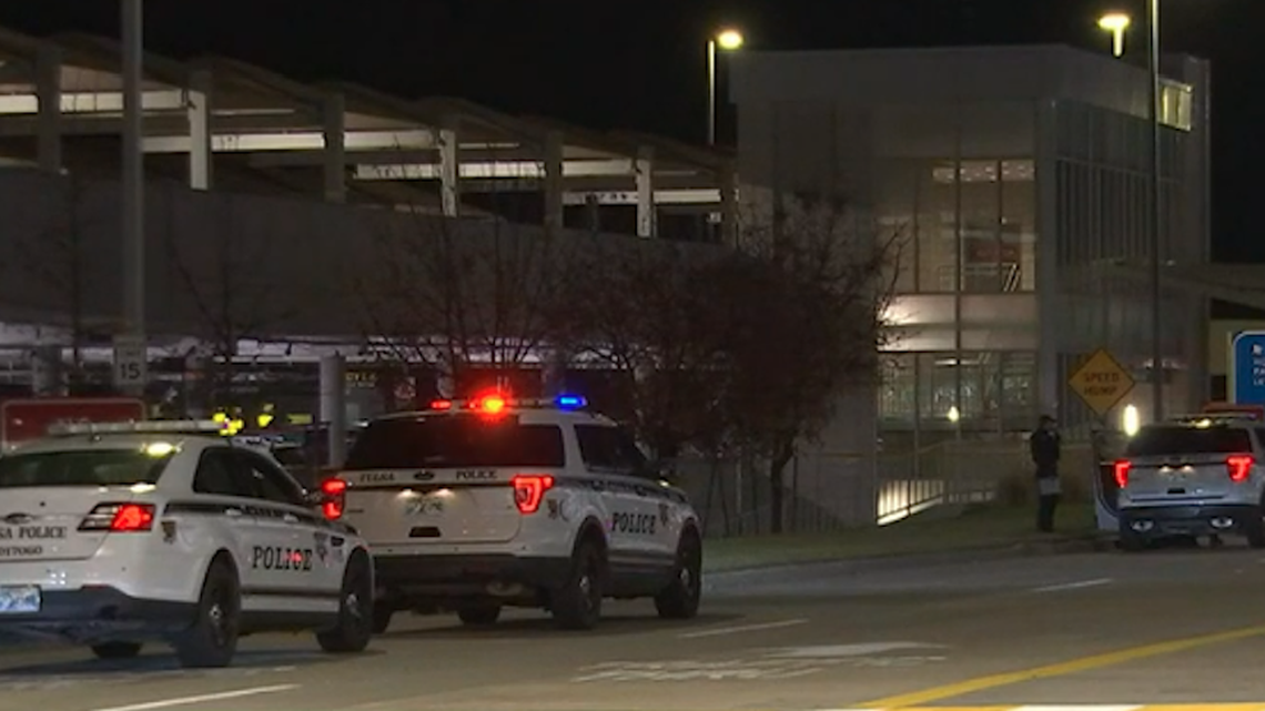 A police officer was shot after chasing a man who shot his wife outside Tulsa International Airport, police say.
