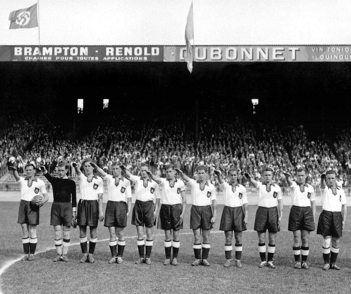 German national soccer team players execute the Nazi salute at the Parc des Princes stadium in Paris, before the start of their World Cup match against Switzerland on June 4, 1938. (From L : Hans Mock, Rudi Raftl, Willi Schmaus, Jupp Gauchel, Rudi Gellesh, Ernst Lehner, Paul Janes, Willi Hahnemann, Anderl Kupfer, Hans Pesser, Albin Kitzinger).