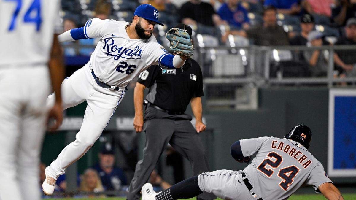 Detroit Tigers’ Miguel Cabrera steals third base as the throw from home to Kansas City Royals third baseman Emmanuel Rivera (26) gets past him during the seventh inning of a baseball game, Tuesday, July 12, 2022, in Kansas City, Mo. (AP Photo/Reed Hoffmann)
