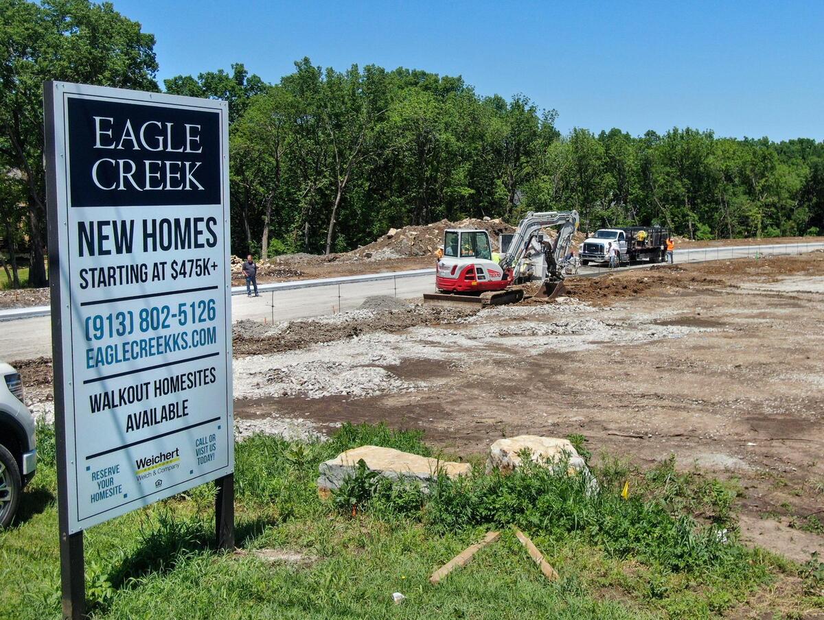 Concrete crews work on curbs for the new streets in the new Eagle Creek subdivision under development by Cottage Creek Development in De Soto, Kansas. The new subdivision is located on 14 wooded acres and will feature 27 single-family homes near West 87th Street and Penner Avenue.