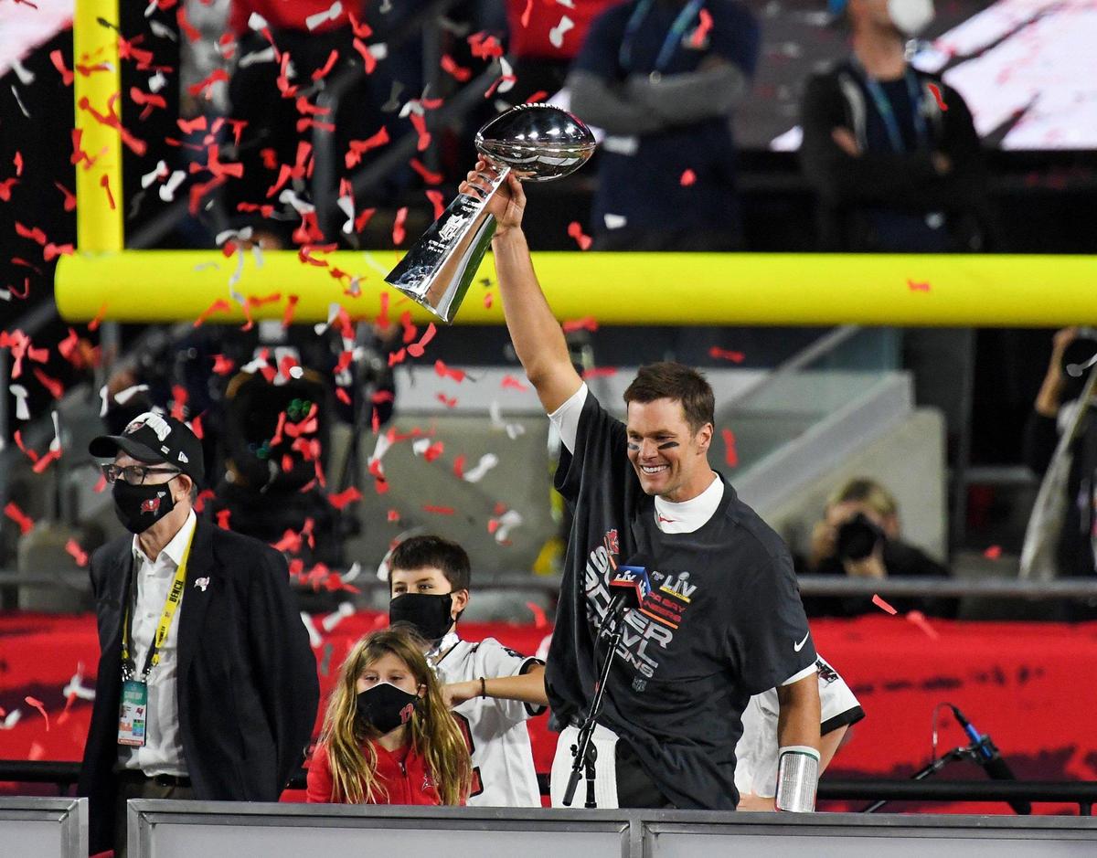 Tampa Bay Buccaneers quarterback Tom Brady lifts the Lombardi Trophy after the Tampa Bay Buccaneers defeated the Kansas City Chiefs 31-9 in Super Bowl LV at Raymond James Stadium in Tampa, Sunday, Feb. 7, 2021.