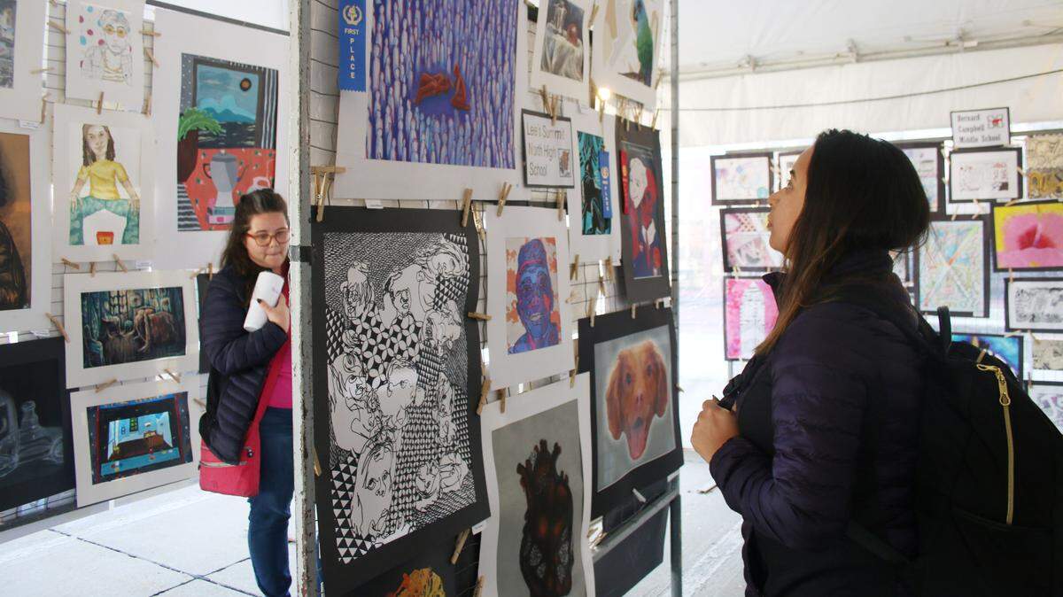 Brandi Stangle of Kansas City and Katy Lara of Grandview check out the many works of art entered in the student categories at the Summit Art Festival Oct. 11.
