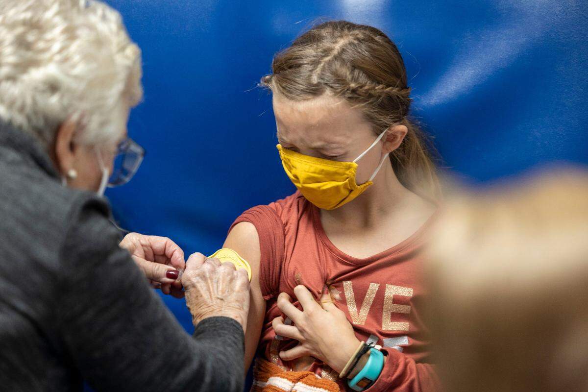 Evie Edwards, 9, receives her first dose of the COVID-19 vaccine at Children’s Mercy Hospital Kansas in Overland Park on Nov. 6.