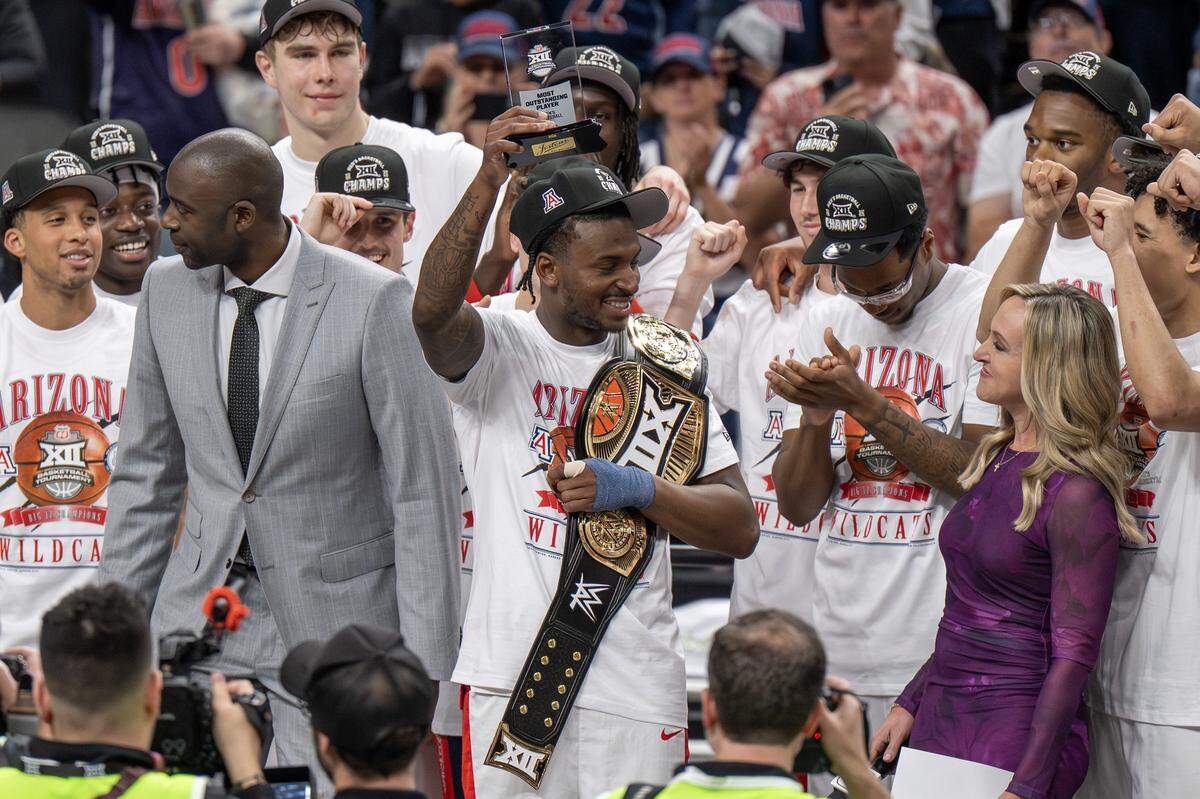 Arizona guard Jaden Bradley (0) celebrates after winning the Most Outstanding Player award following Arizona's 79-74 victory over Houston in the Big 12 Men's Basketball Tournament Championship game at T-Mobile Center on Saturday, March 14, 2026, in Kansas City.