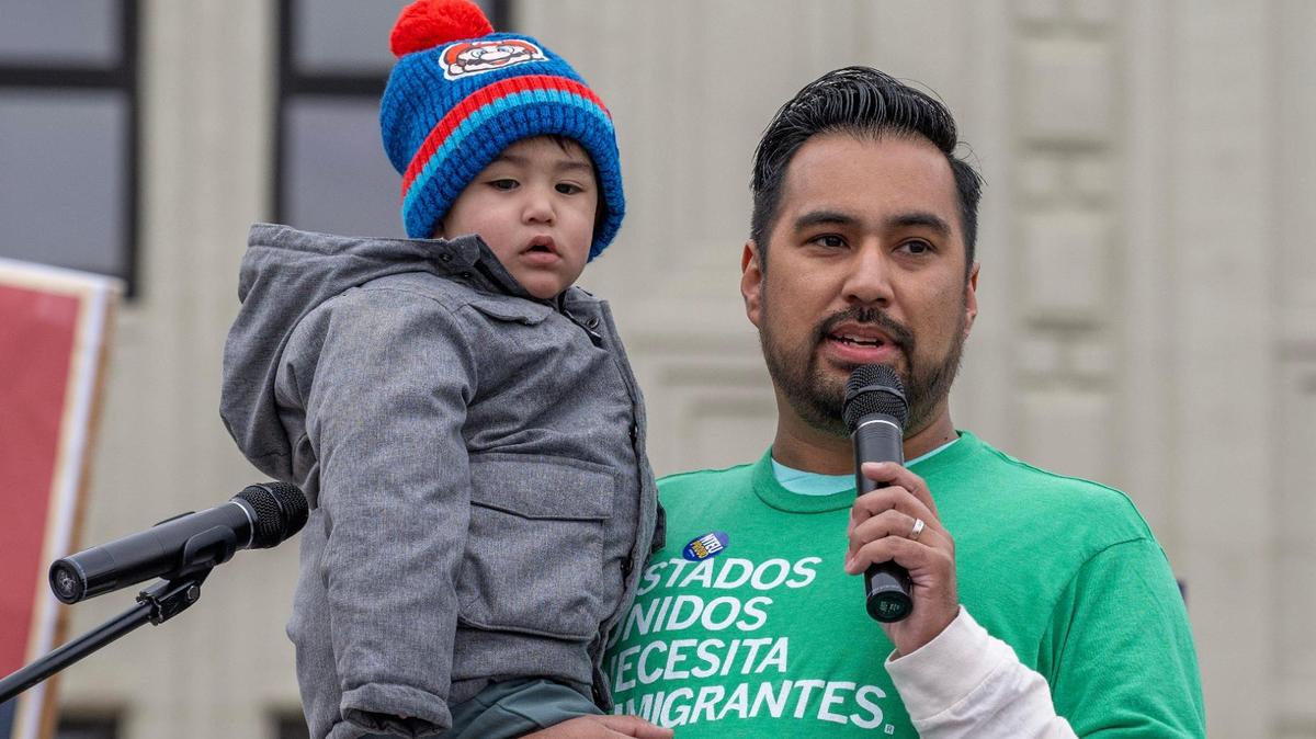 Jackson County Legislator Manuel Abarca IV holds his son while speaking during a rally in support of federal workers on Wednesday, March 12, 2025, in Kansas City.