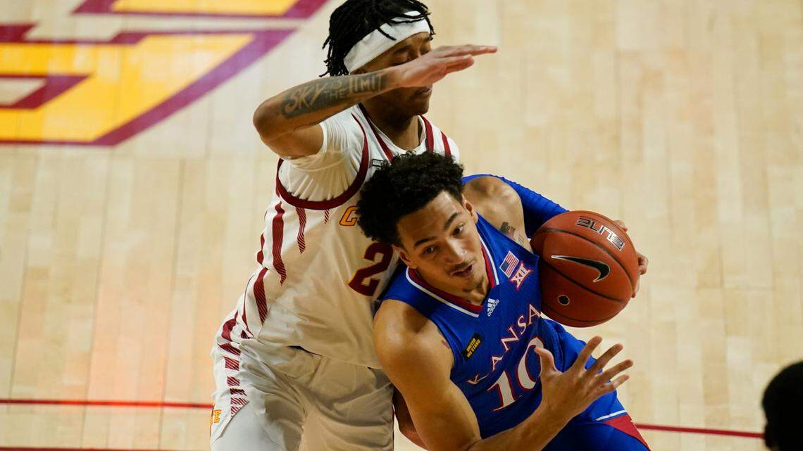 Kansas forward Jalen Wilson (10) drives past Iowa State guard Jaden Walker, left, during the first half of an NCAA college basketball game, Saturday, Feb. 13, 2021, in Ames, Iowa. (AP Photo/Charlie Neibergall)