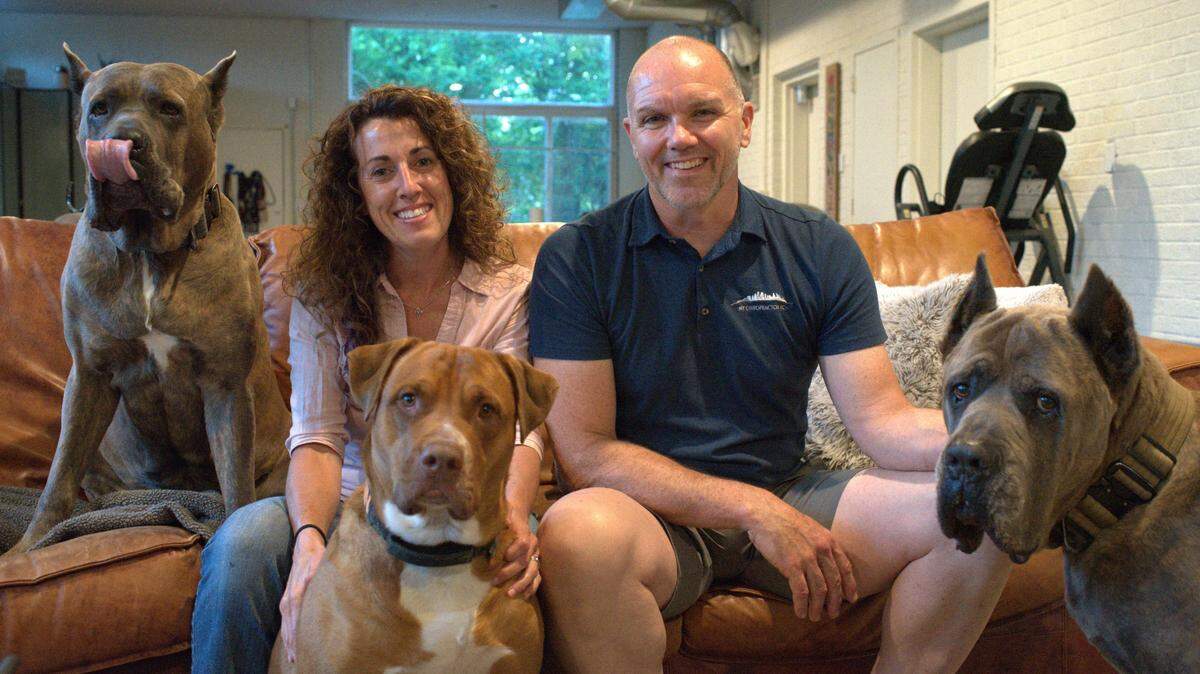 Emily McLeod, left, and Dave Jennings, right, pose for a photograph with three of their dogs inside their Kansas City, Kansas home. The couple have been involved in a lengthy legal dispute over “Oscar,” a nationally-recognized show dog they raised since puppyhood. The case recently went before the Kansas Supreme Court before it was sent back to Wyandotte County District Court for further proceedings.