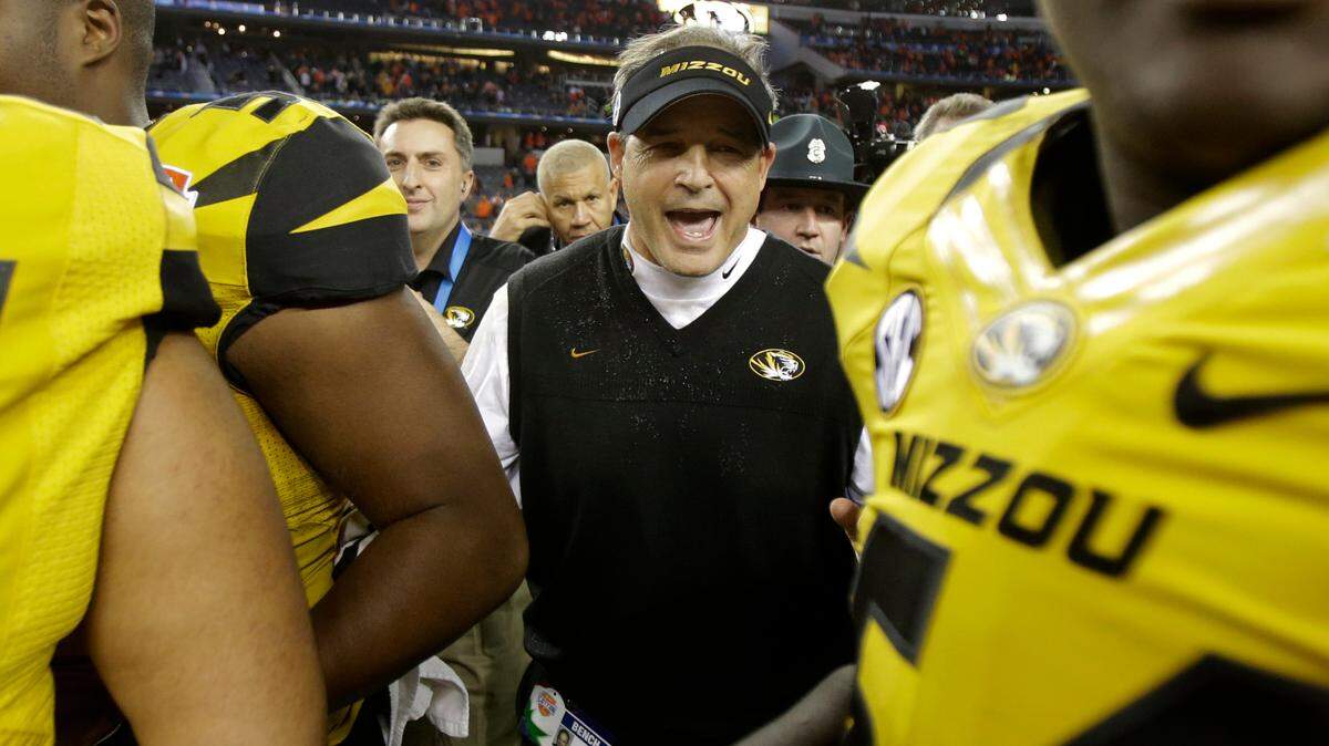 Missouri head coach Gary Pinkel celebrates after beating Oklahoma State 41-31 at the Cotton Bowl NCAA college football game, Friday, Jan. 3, 2014, in Arlington, Texas. (AP Photo/Tim Sharp)