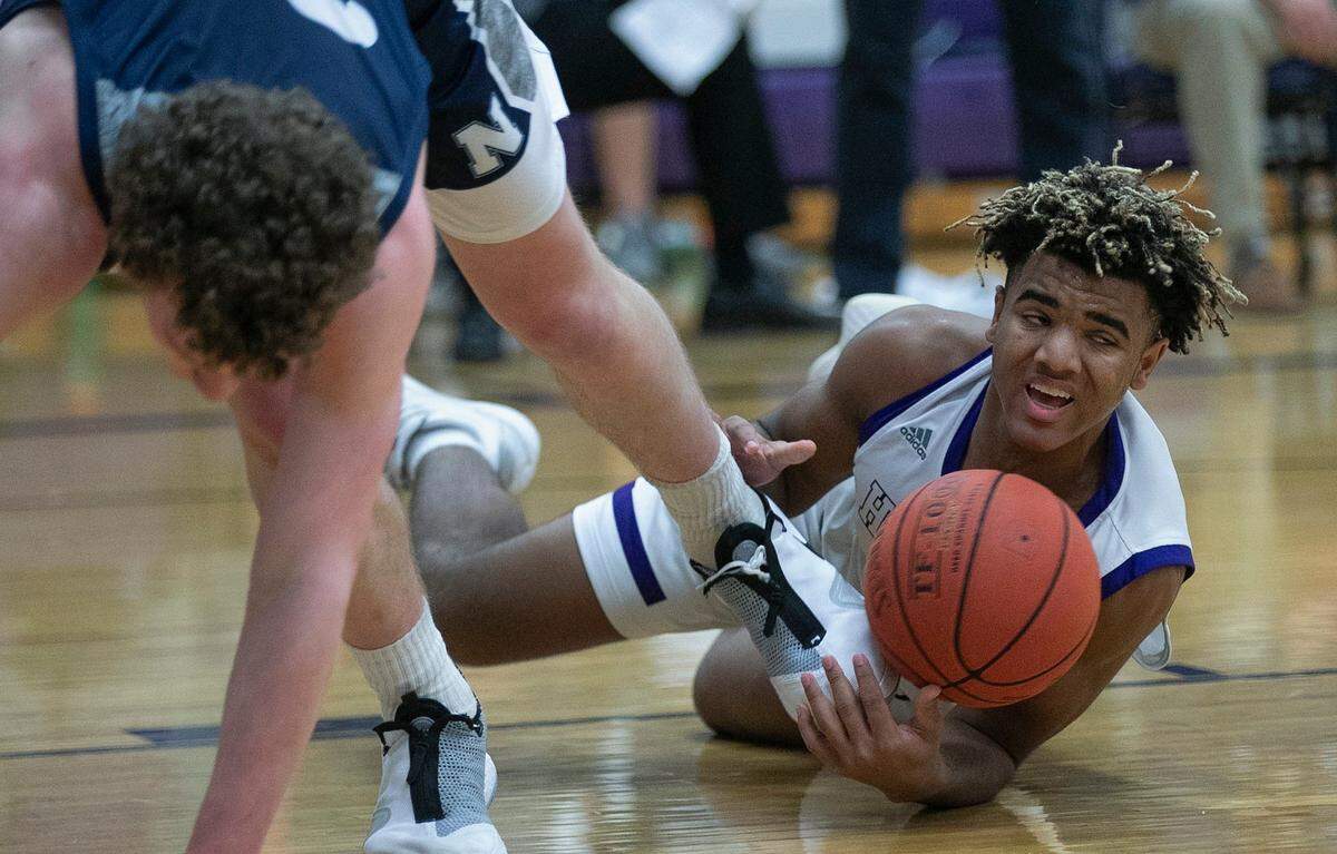 Grant Stubblefield of Blue Valley Northwest (right) scraps for the ball with Andrew Orr of Blue valley North during a game in February. This week, Stubblefield was one of four area high schoolers selected for the first Jr. NBA Court of Leaders.