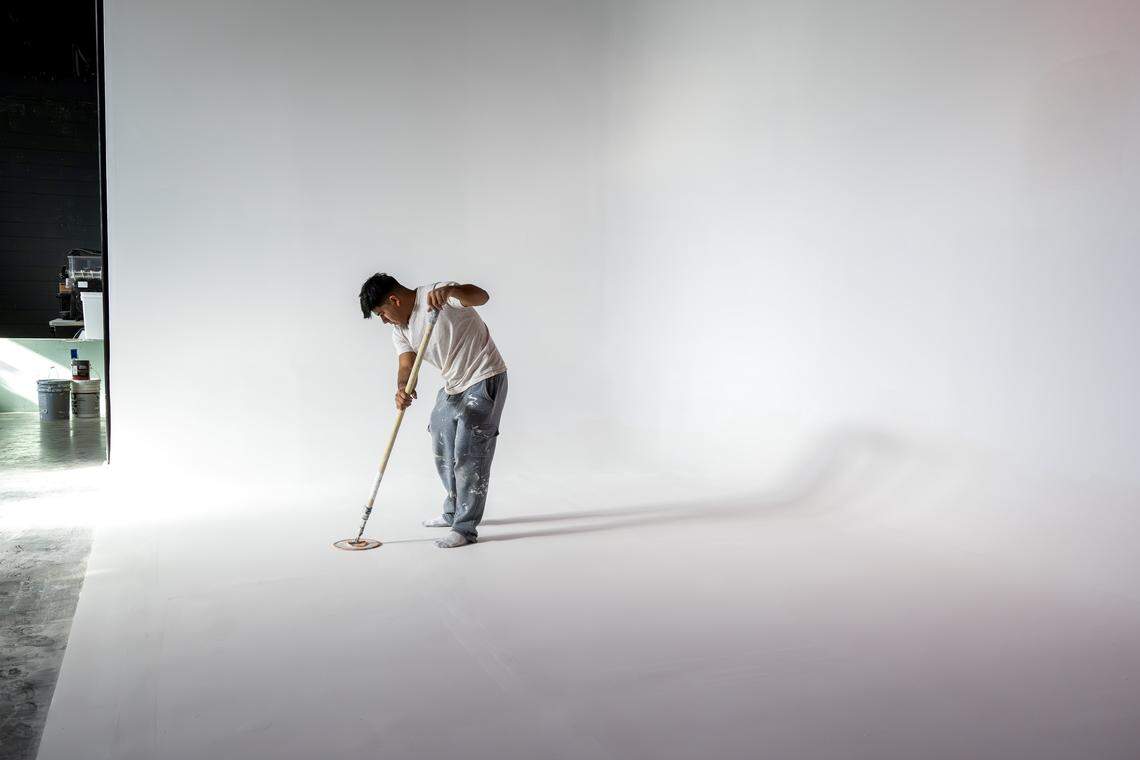A worker sands a cyclorama wall inside the DISTRKCT space at Agnes Arts on Tuesday, Nov. 25, 2025, in Kansas City.
