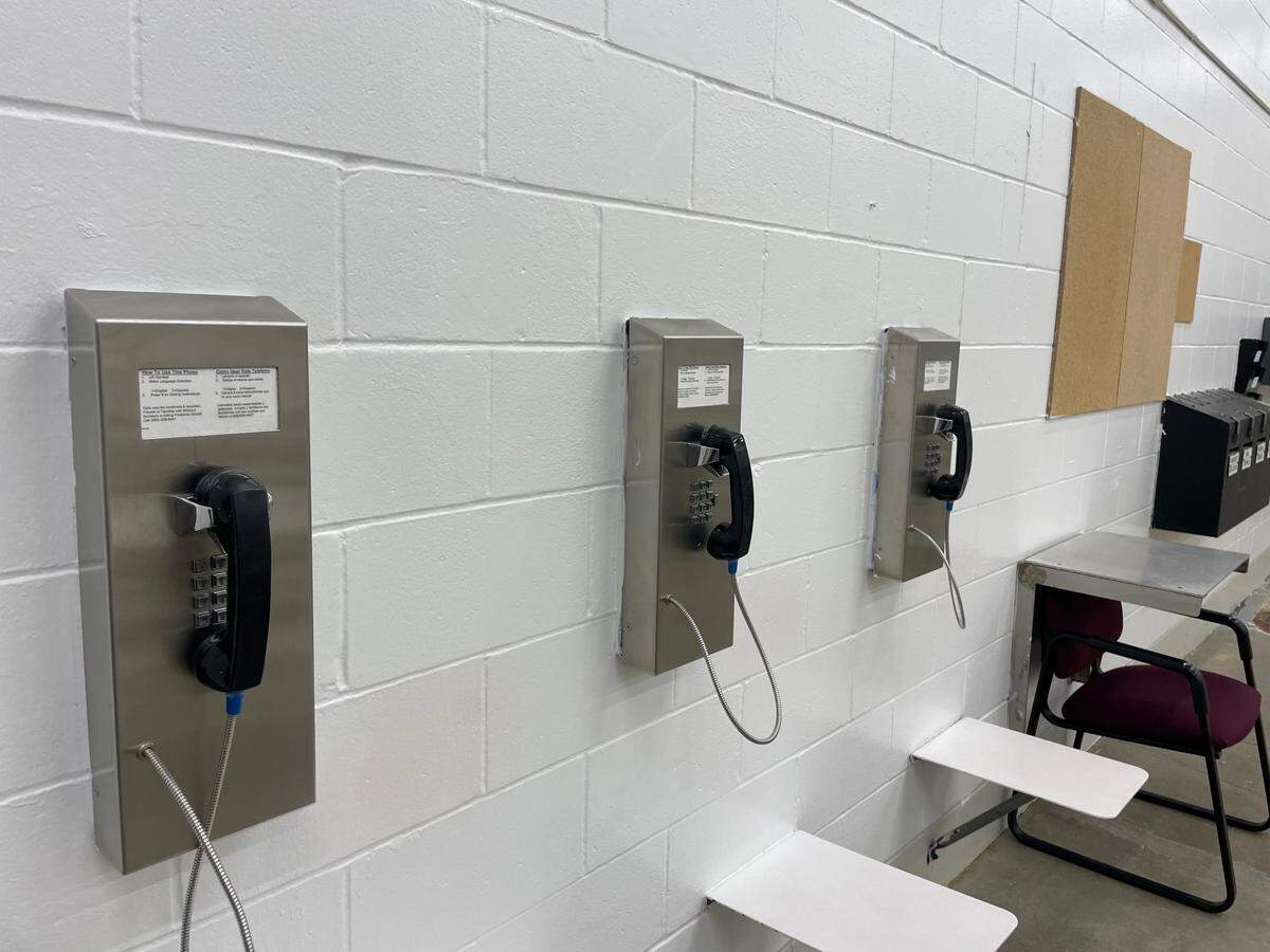 A line of telephones in one of the day rooms at the Midwest Regional Reception Center in Leavenworth, Kansas.