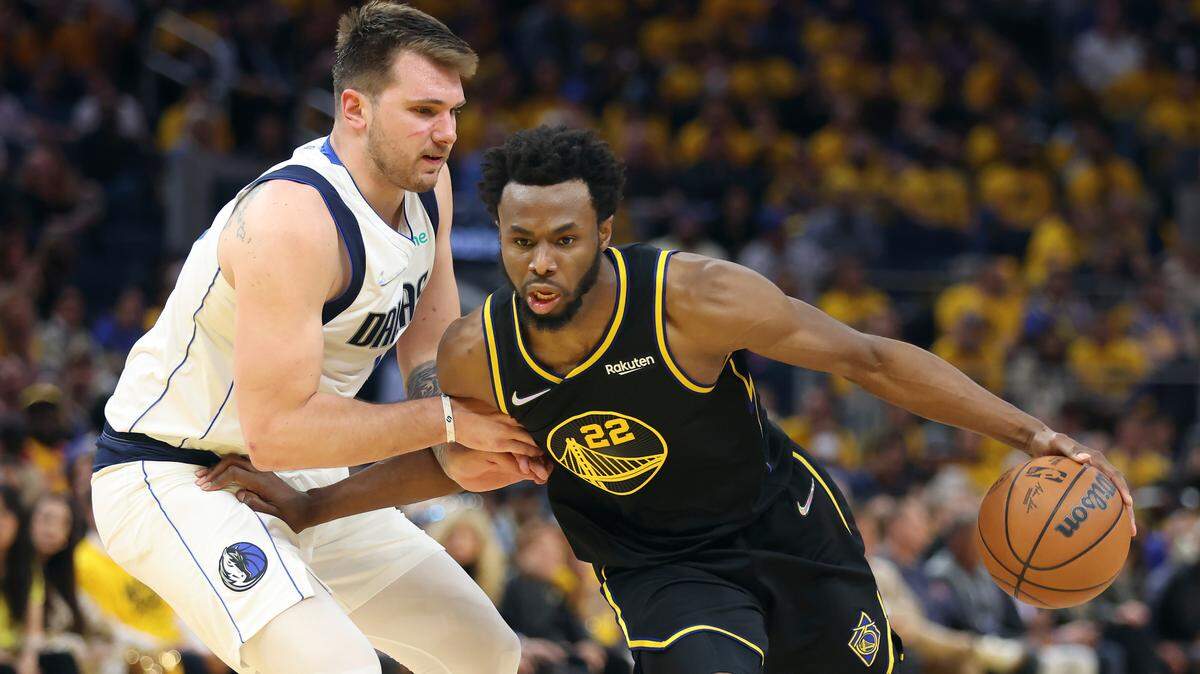 Golden State Warriors forward Andrew Wiggins (22) drives to the basket against Dallas Mavericks guard Luka Doncic during the second half of Game 1 of the NBA basketball playoffs Western Conference finals in San Francisco, Wednesday, May 18, 2022. (AP Photo/Jed Jacobsohn)